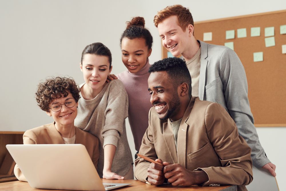 The Galaner team gathered around a laptop in the office